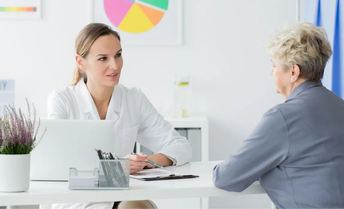 Body contouring consultation esthetician discussingbody contouring treatments for stubborn belly fat to an older female client
