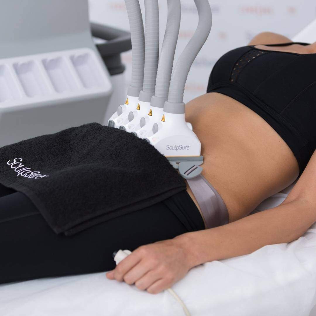 Image of a woman haveing a non-invasive  fat reduction treatment on her abdominals
