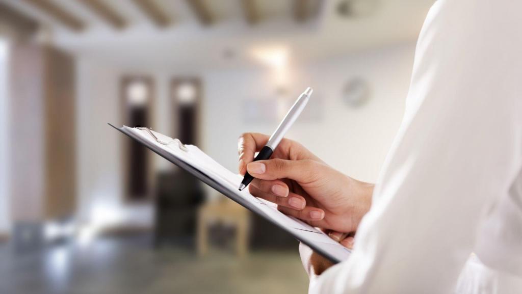 female holding a clipboard and pen