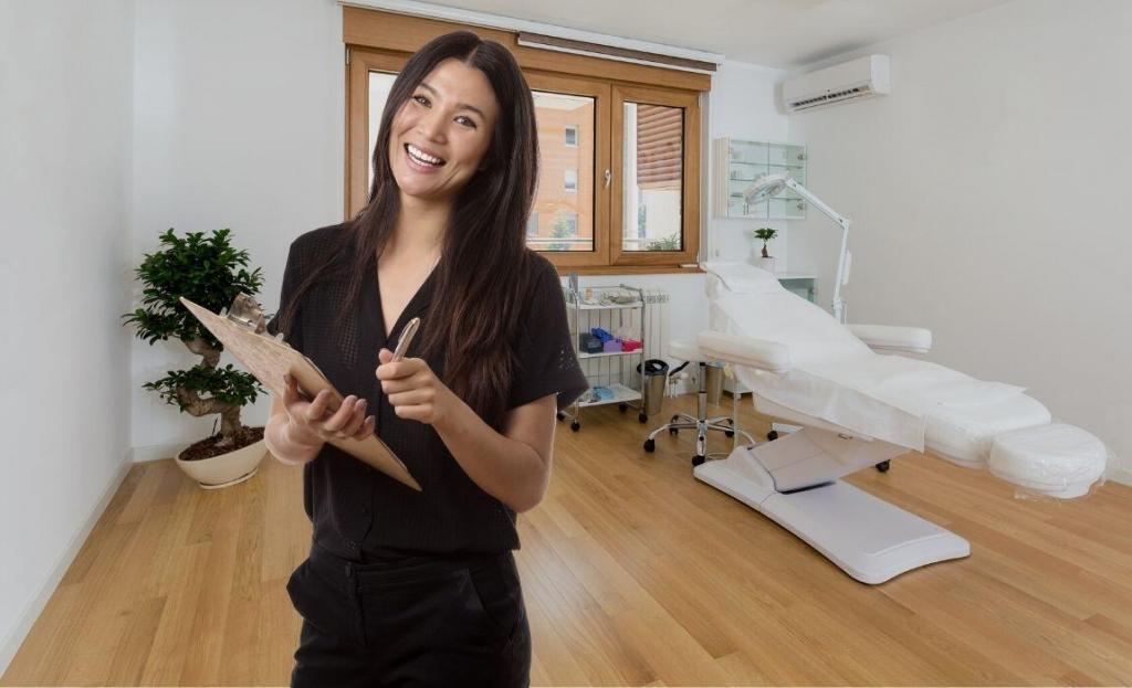 aesthetic treatment room with woman smiling standing with clip board