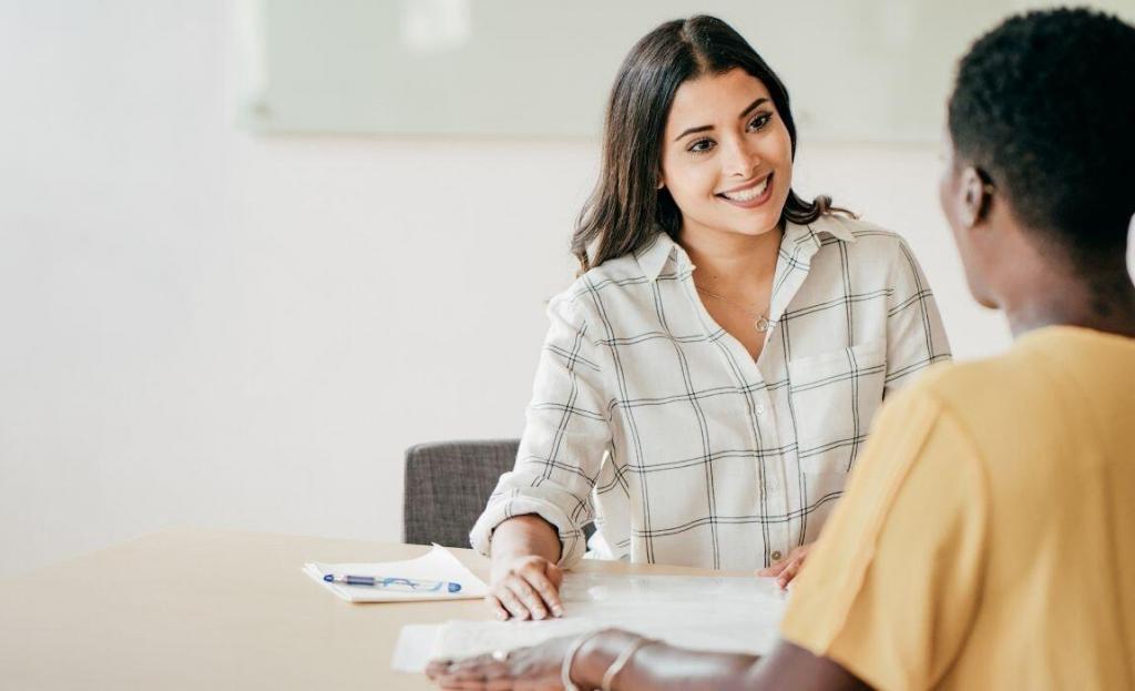 happy business woman in interview sitting across the table from another woman