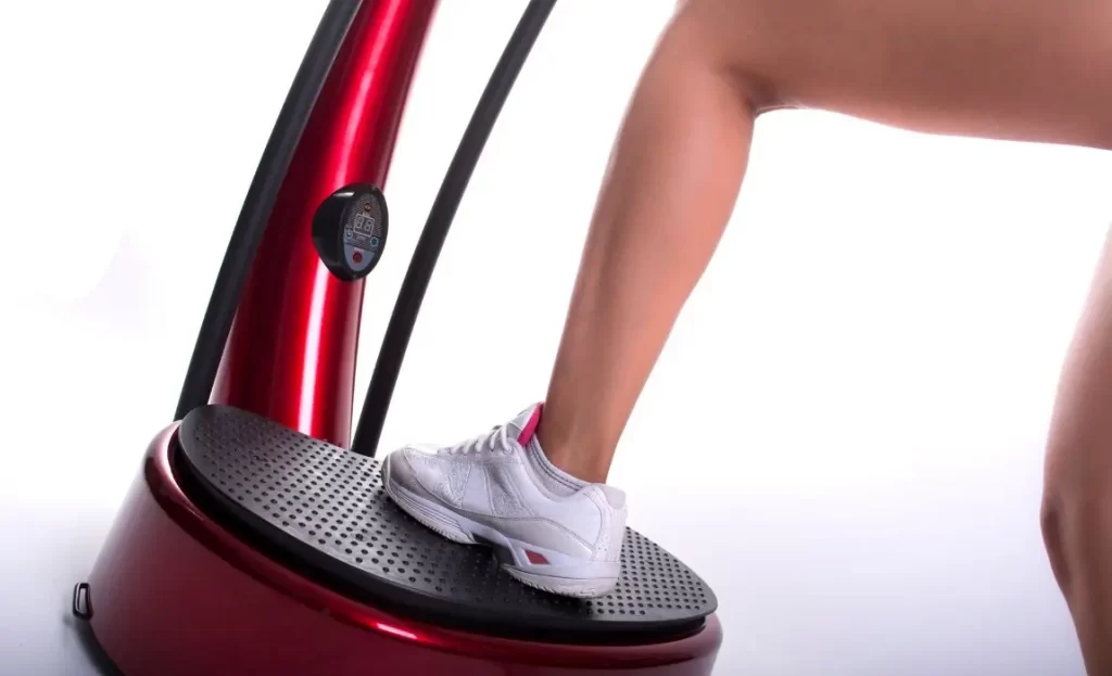 woman's leg stepping on platform forvibration therapy before body contouring treatments