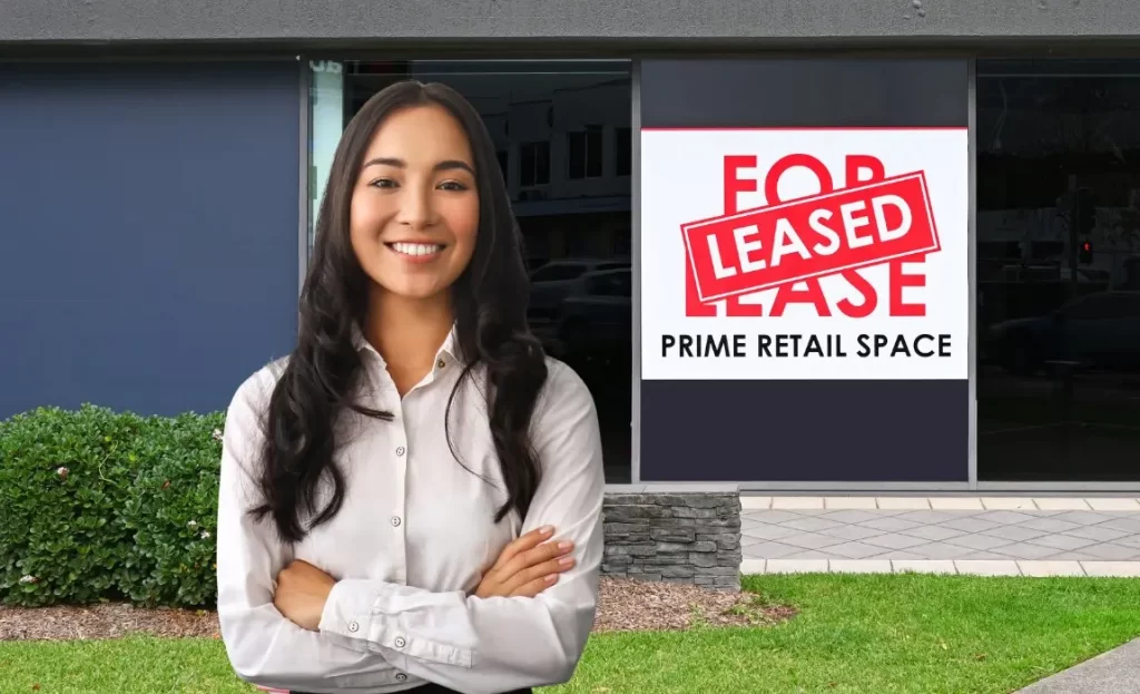 smiling woman standing outside in front of a retail space leased to open your body contouring business