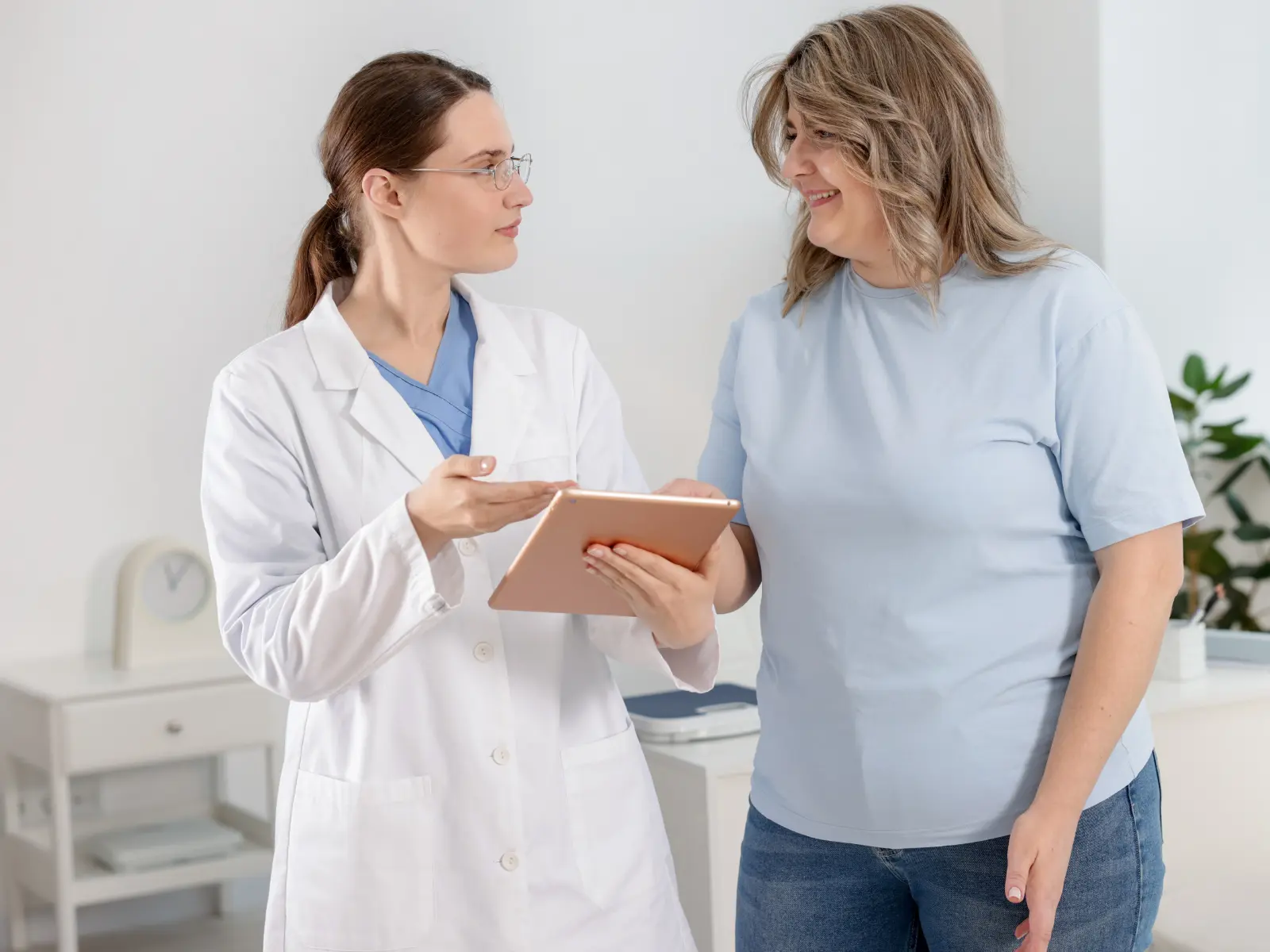 Medical spa practitioner Body Sculpting consultation with happy patient