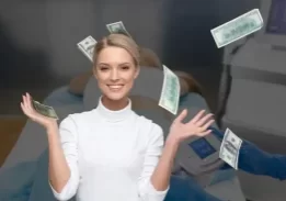 woman throwing money in the air with a fat freezing treatment in the background