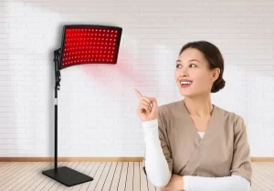 woman pointing to red light therapy lamp